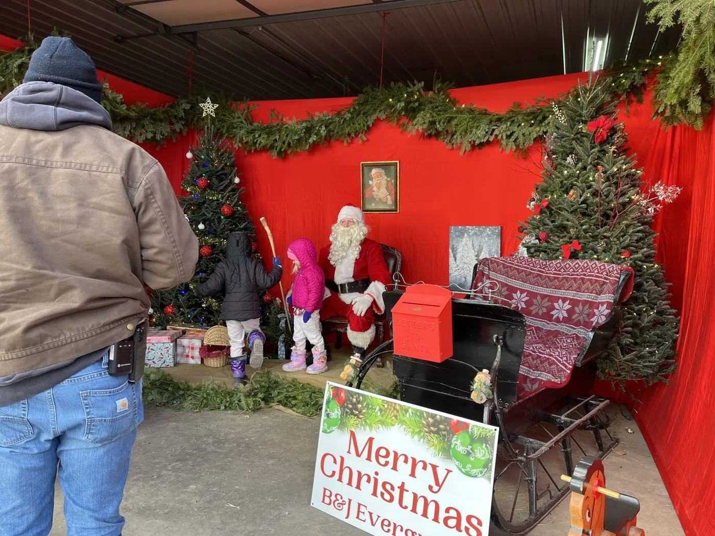 Children visit Santa in his decorated cabin at the Princeton farm